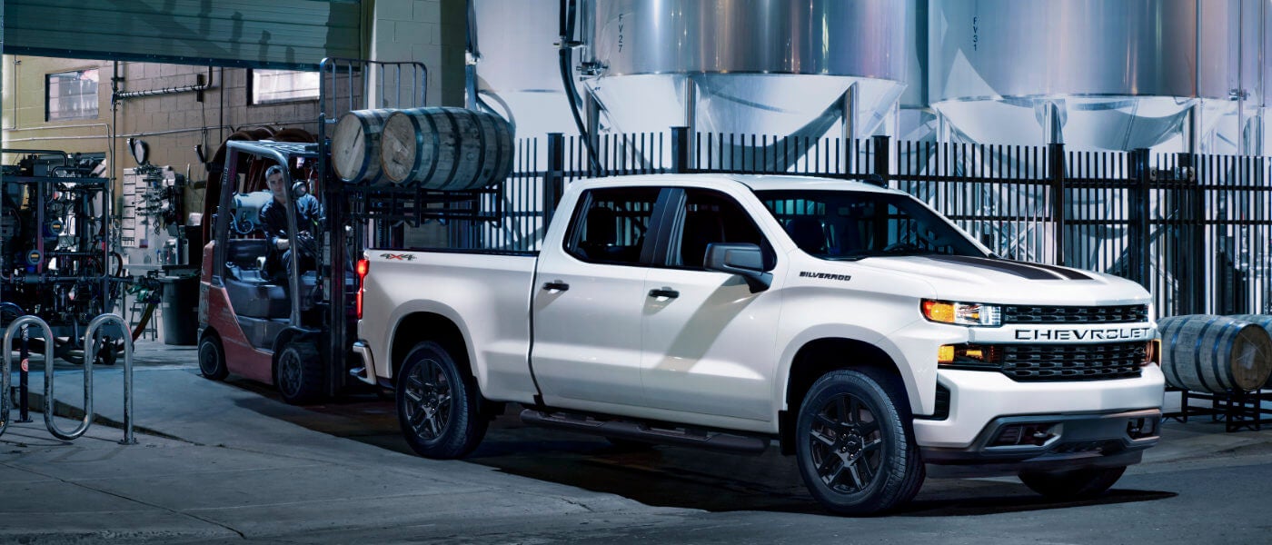 2026 Chevy Silverado 1500 with cargo being loaded into bed