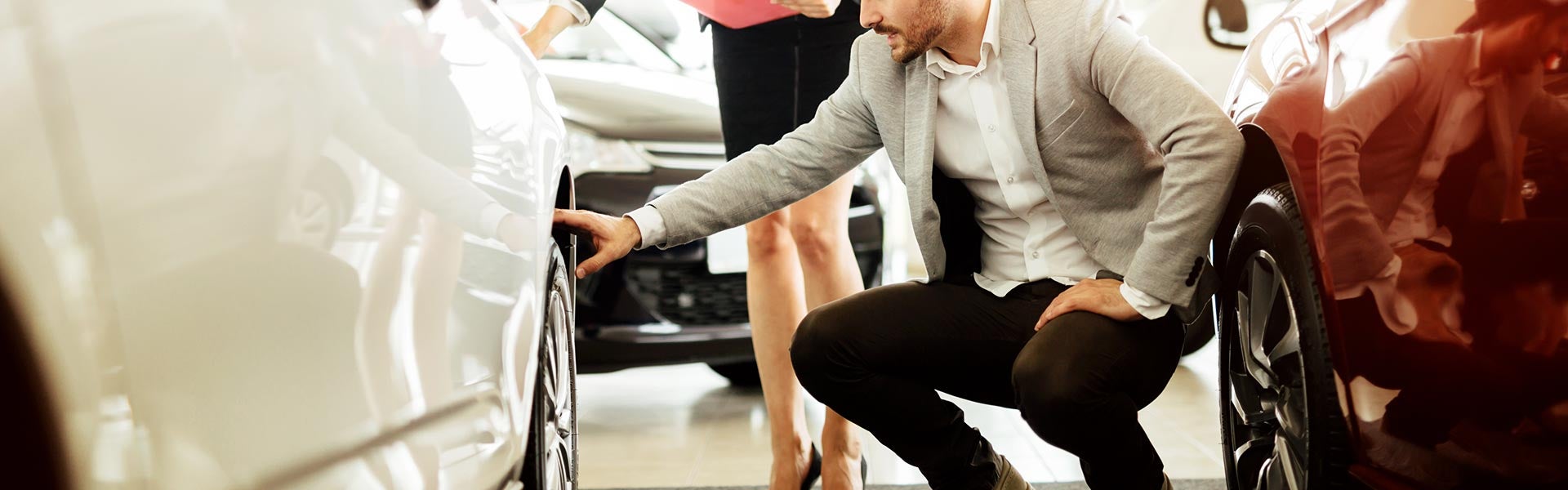 Man inspecting car wheels